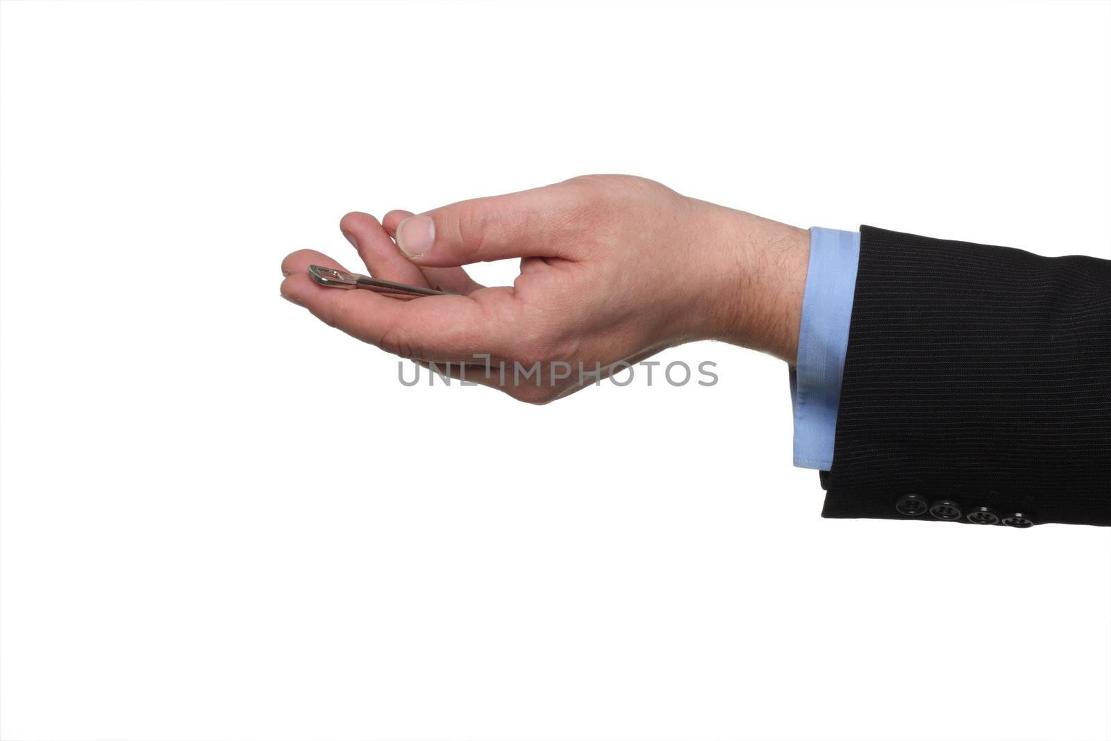 cropped shot of human hand in black suit holding out house keys