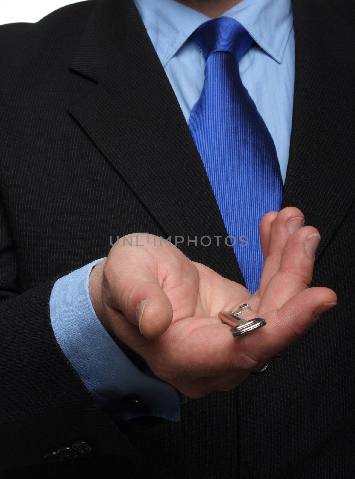 cropped shot of torso part of a man in black suit holding out house keys