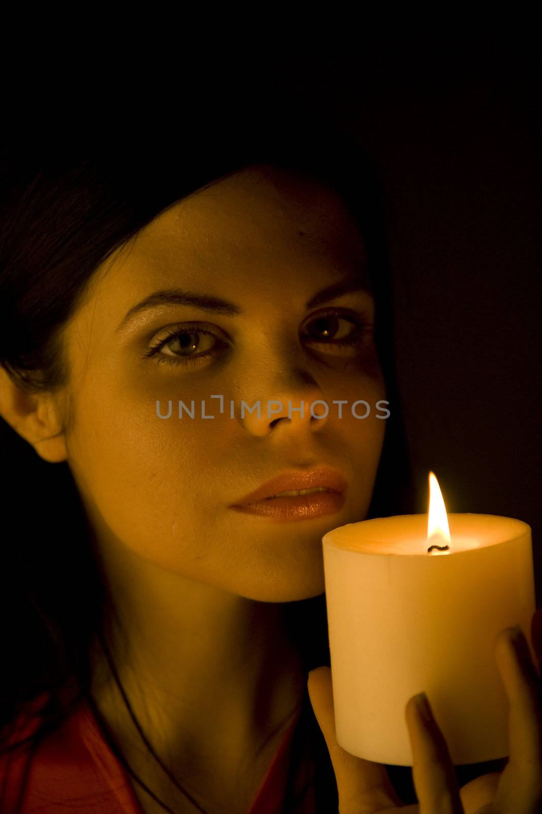 Beautiful woman bathed in soft candle light