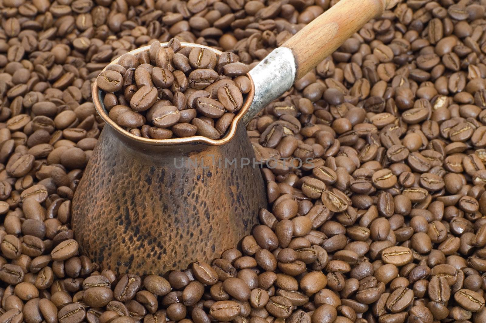 Turkish coffee pot and coffee beans.