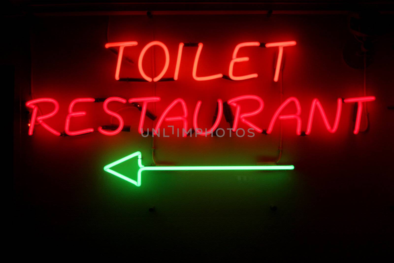 closeup of a badly worded neonsign in a restaurant