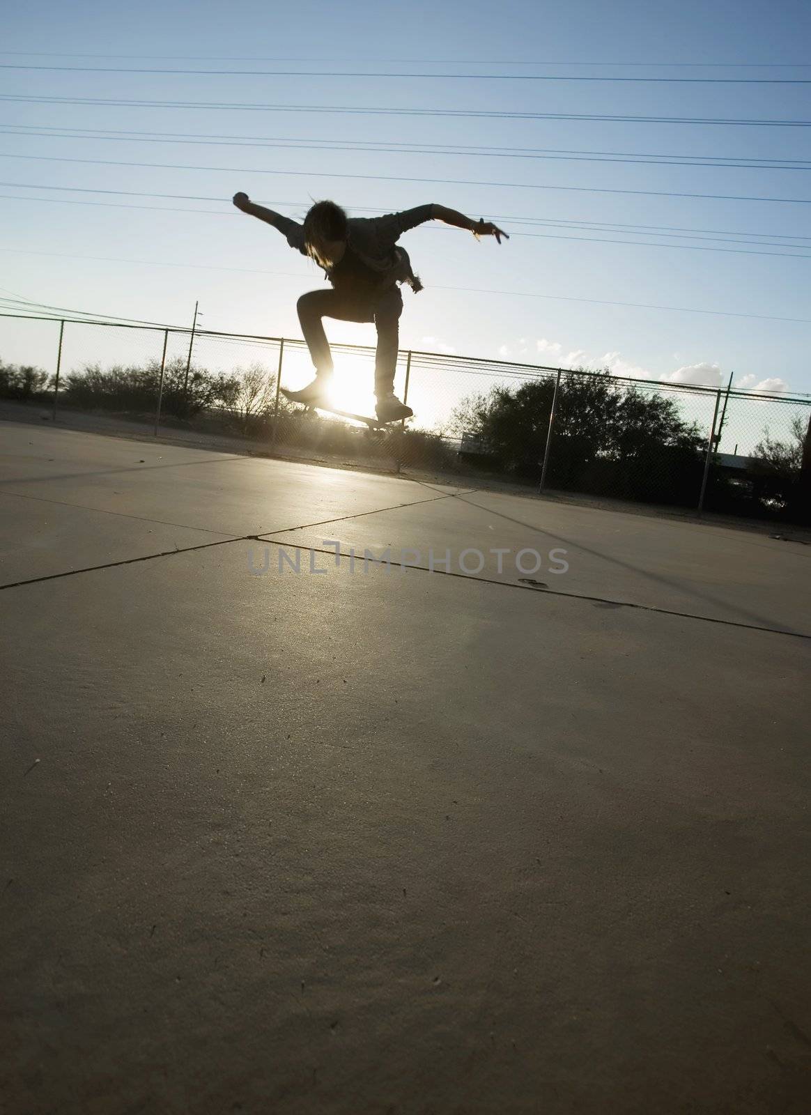 Teenage boy skateboarder with his board.