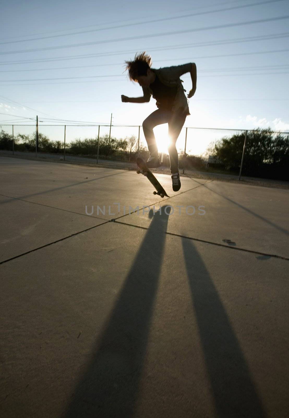 Teenage boy skateboarder with his board.