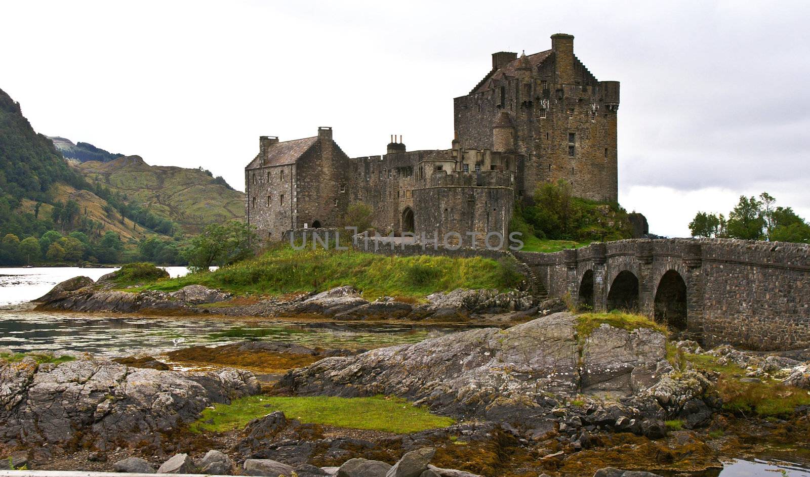 eilean donan castle on a cloudy day at low tide