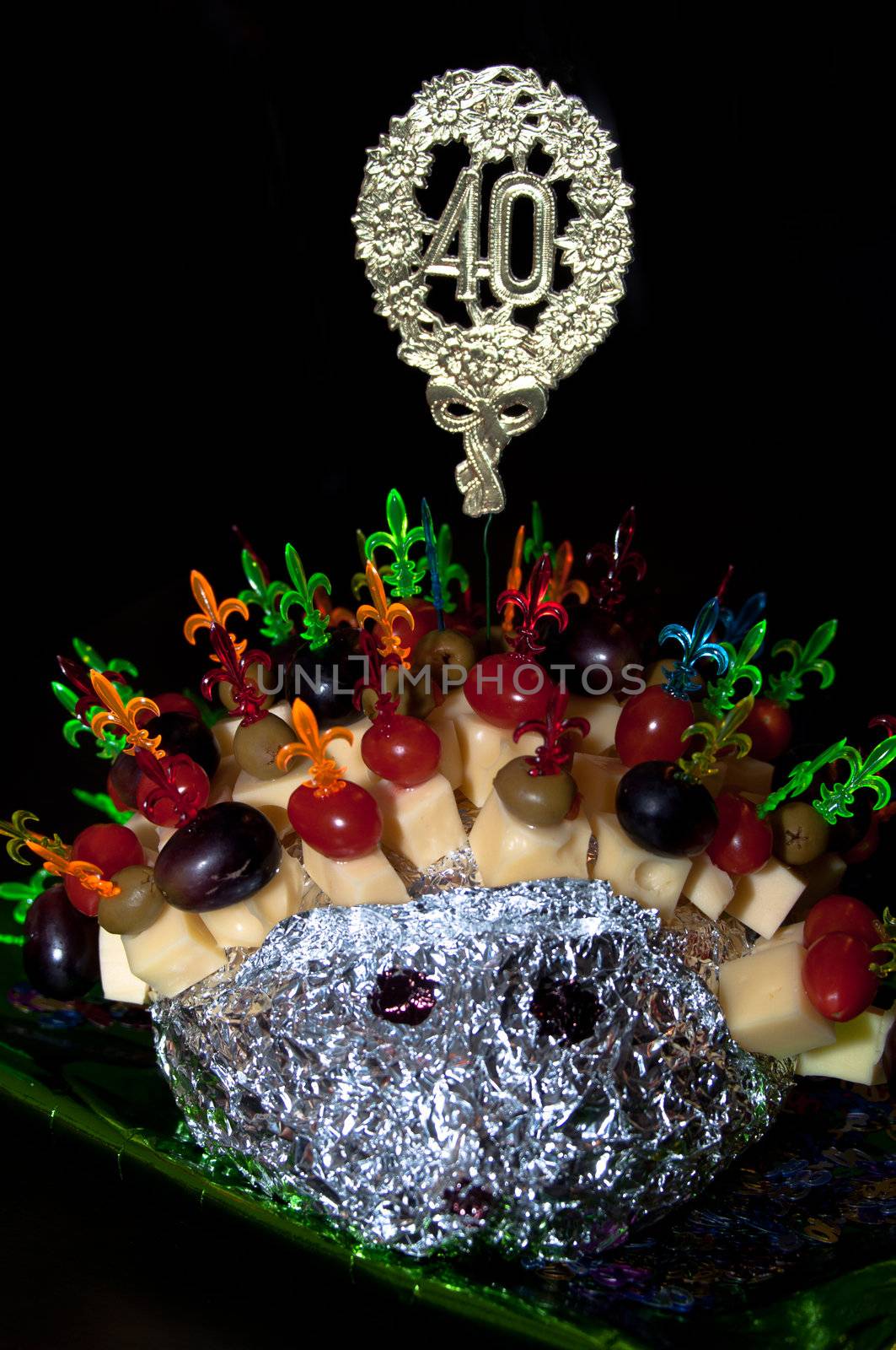 hedgehog made from sticks with delicious food - cheese, olives, tomatoes, grapes
