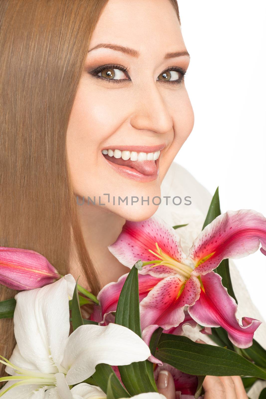 Portrait of young overweight woman holding lilies, smiling with tongue out at camera