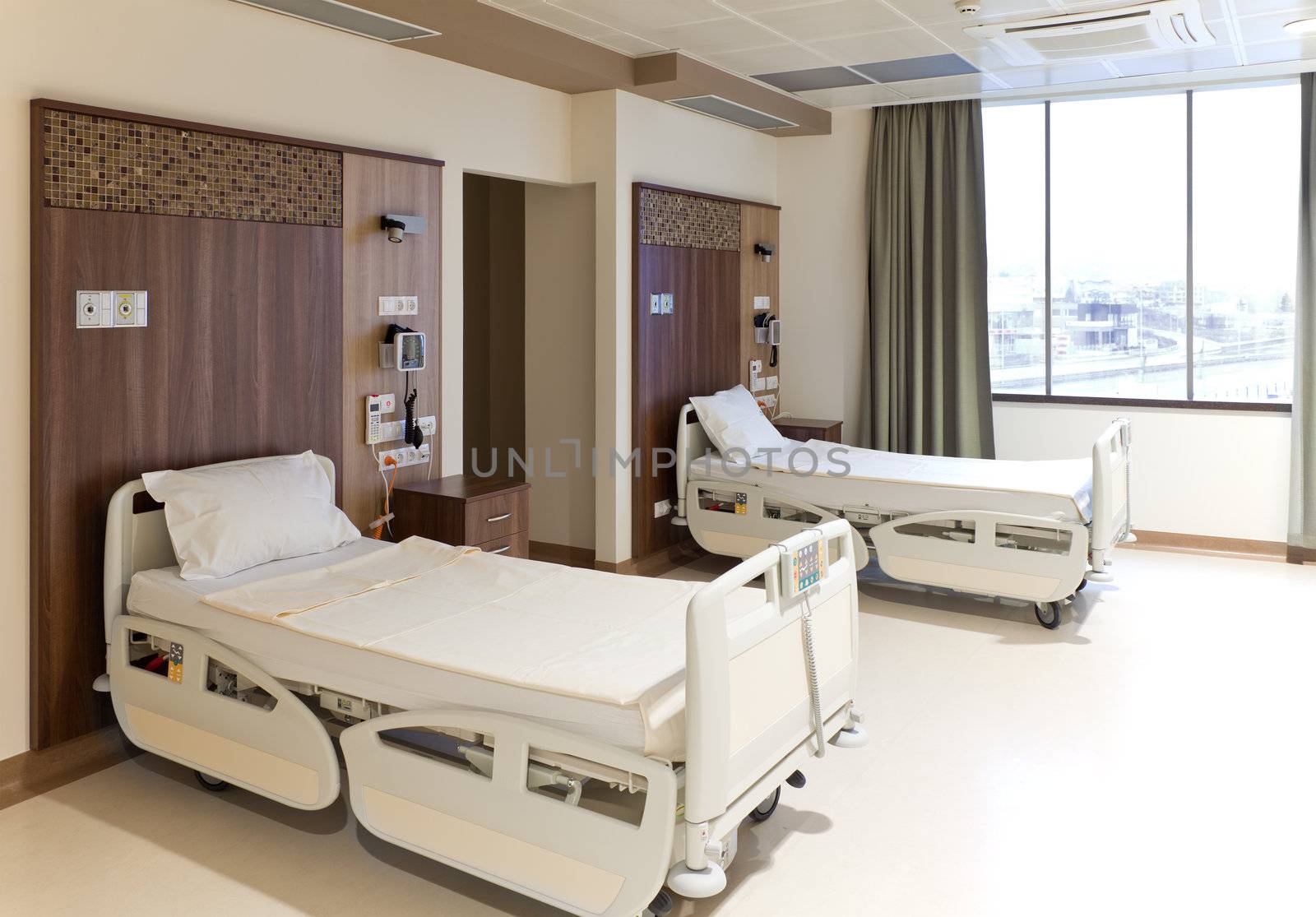 Modern equipped hospital room with two empty beds