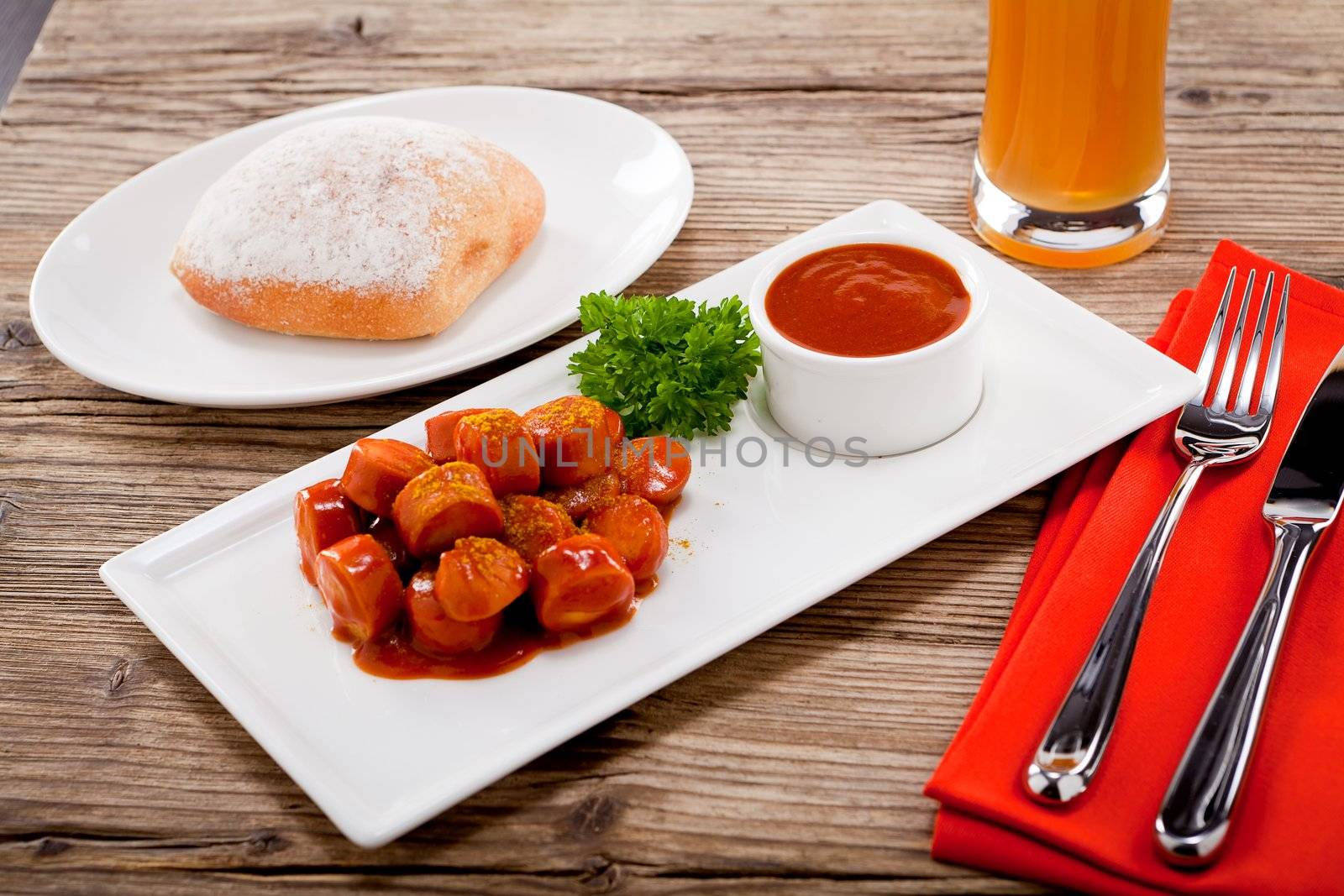 curry wurst spicy sausage with curry and ketchup on wooden background