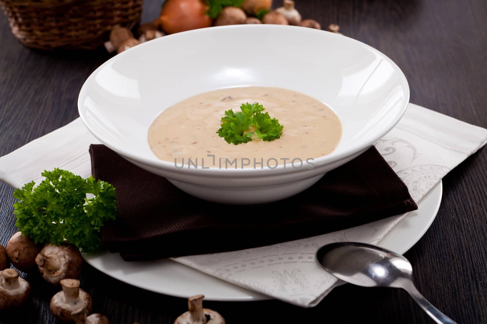 fresh chmapignon cream soup with parsley decorated on wooden table