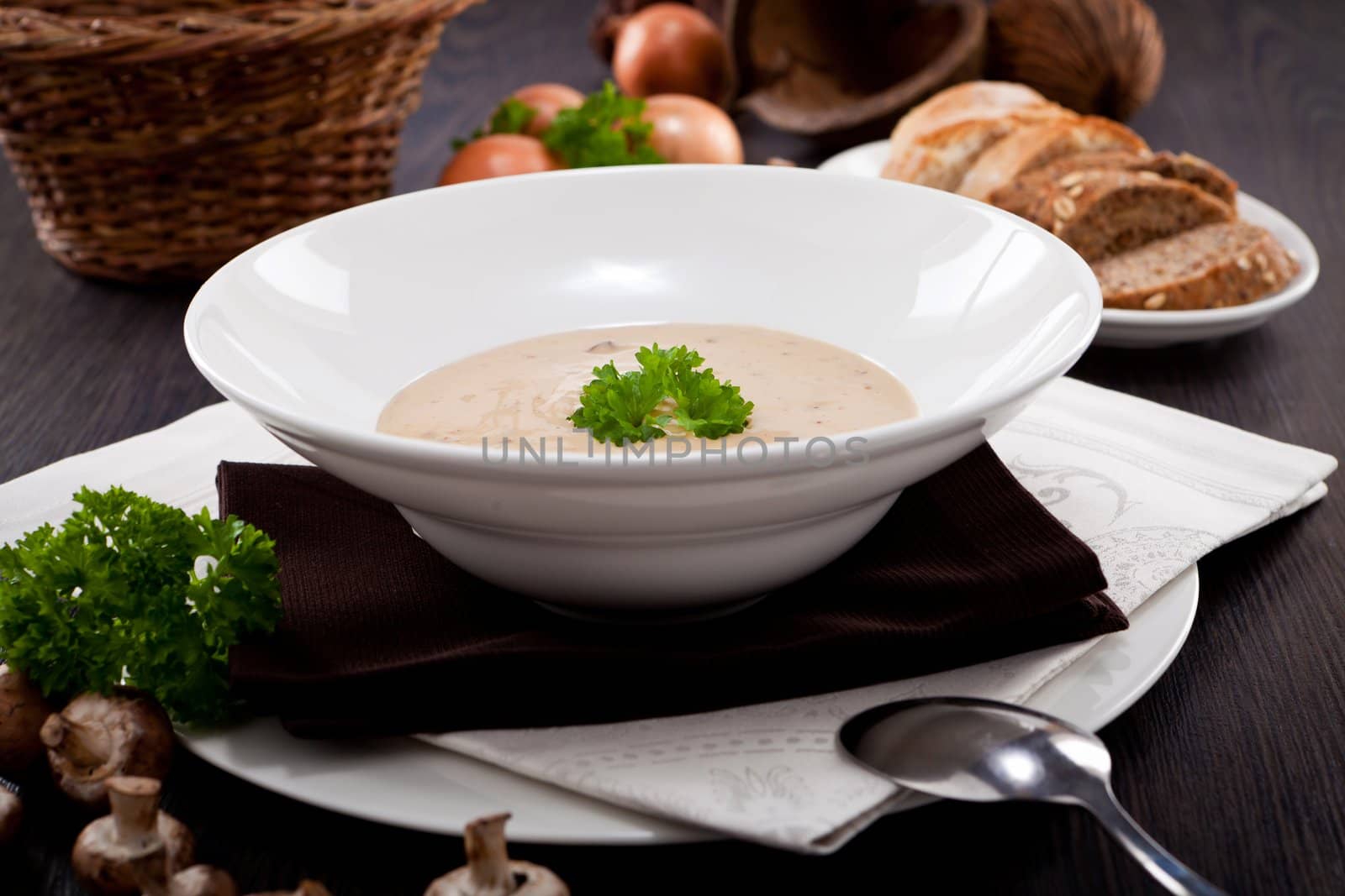 fresh chmapignon cream soup with parsley decorated on wooden table