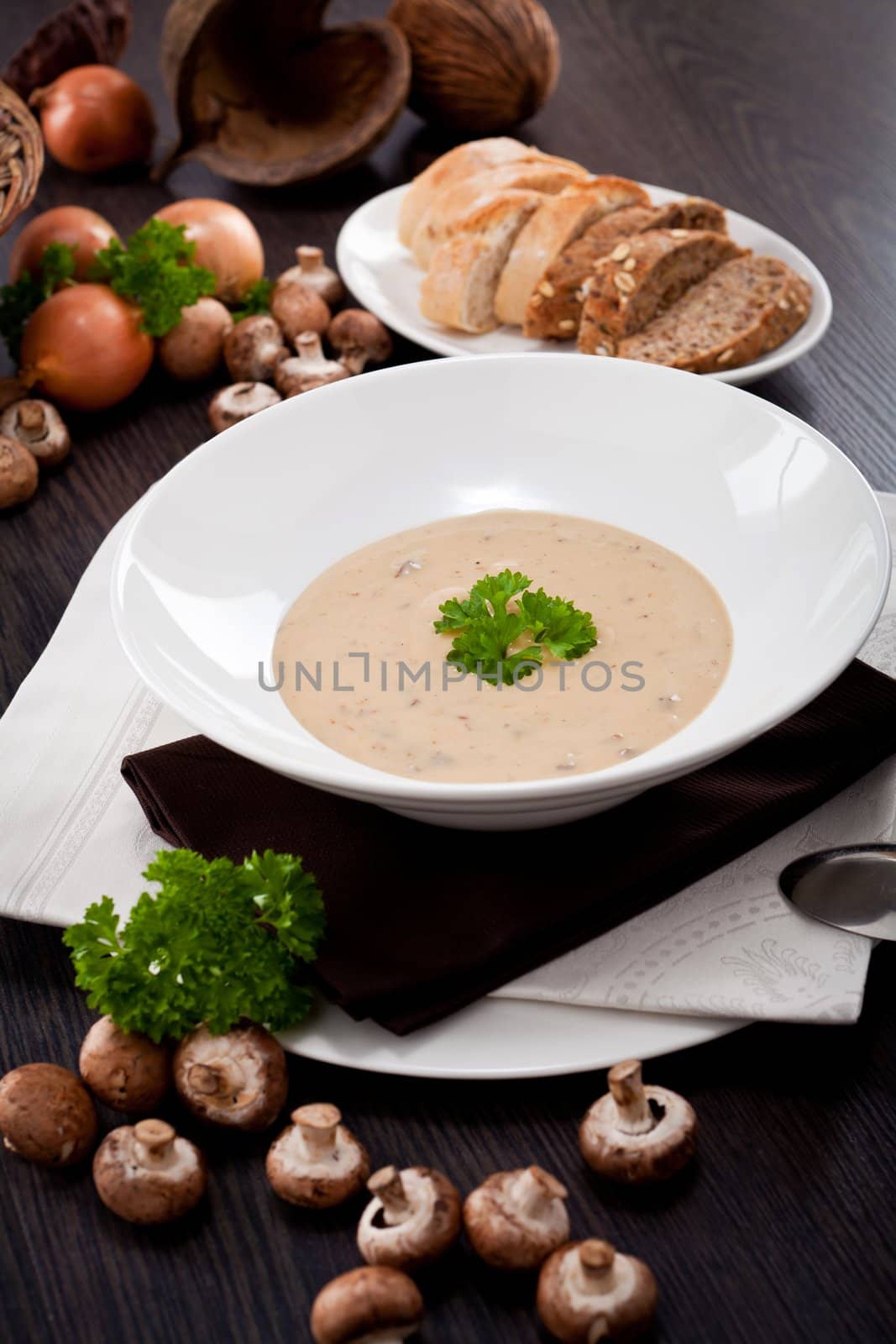 fresh chmapignon cream soup with parsley decorated on wooden table