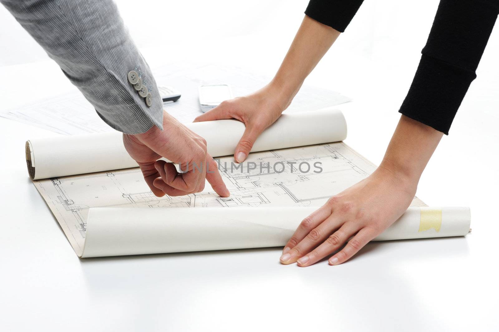 Architect�s hands pointing on the blueprint of new house project 