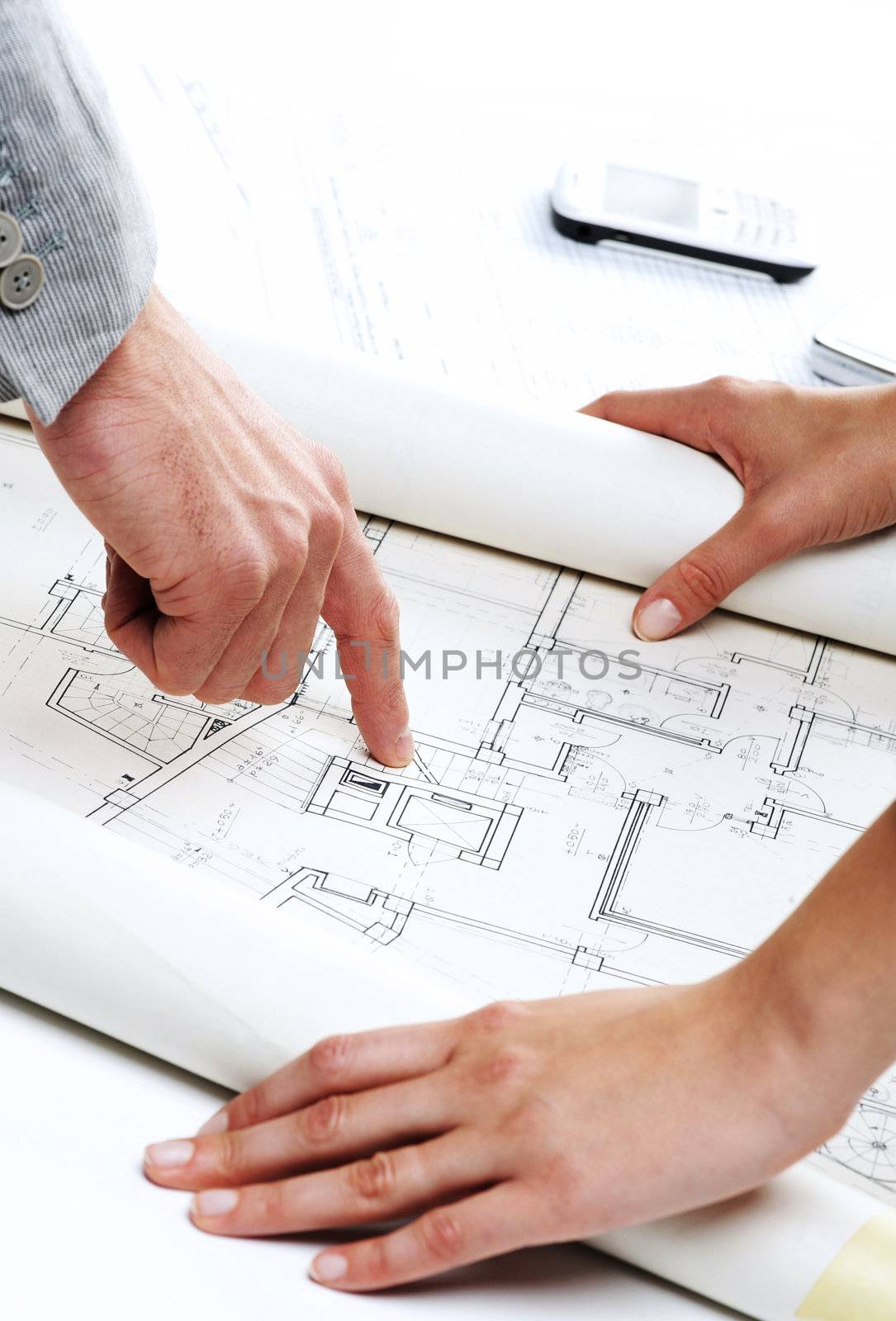 Architect�s hands pointing on the blueprint of new house project 