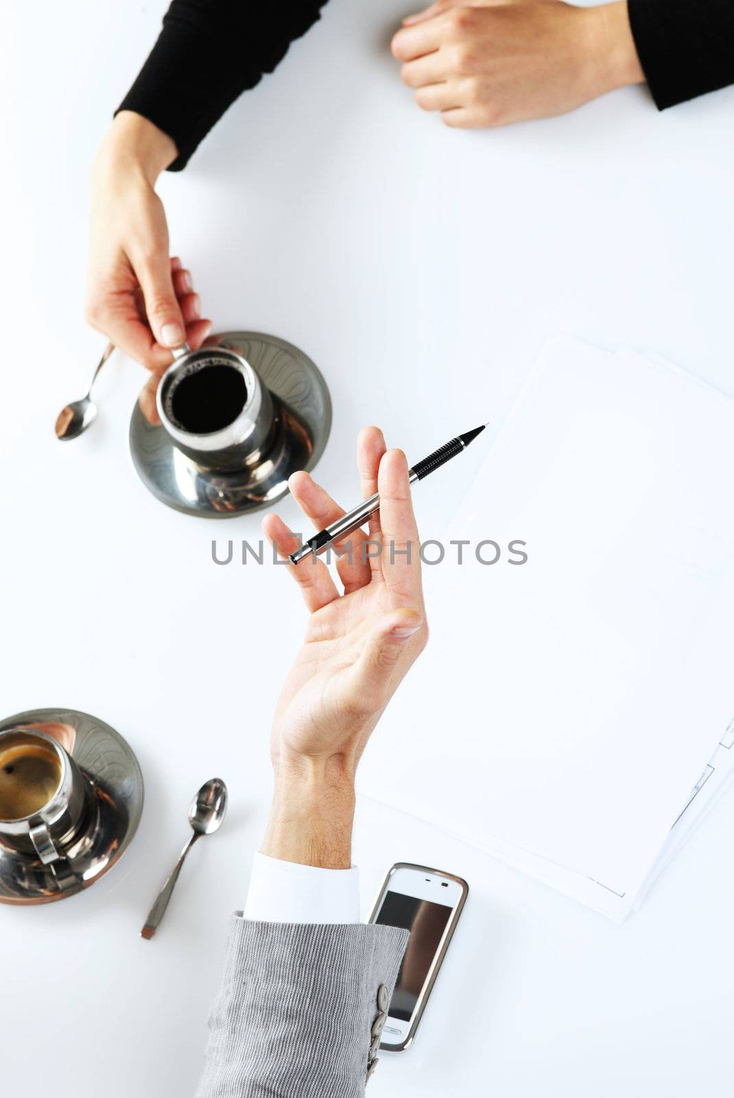 Closeup of hands. Office workers working and drinking coffee