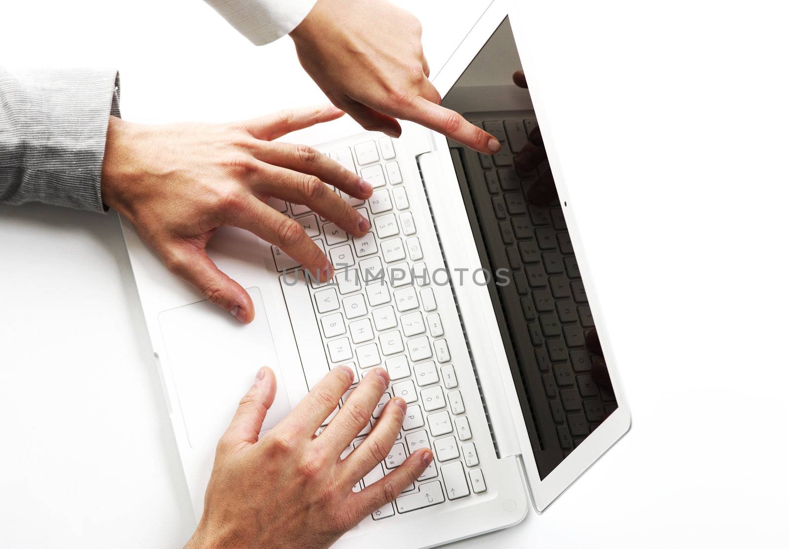  two business peoples at working on laptop, top view