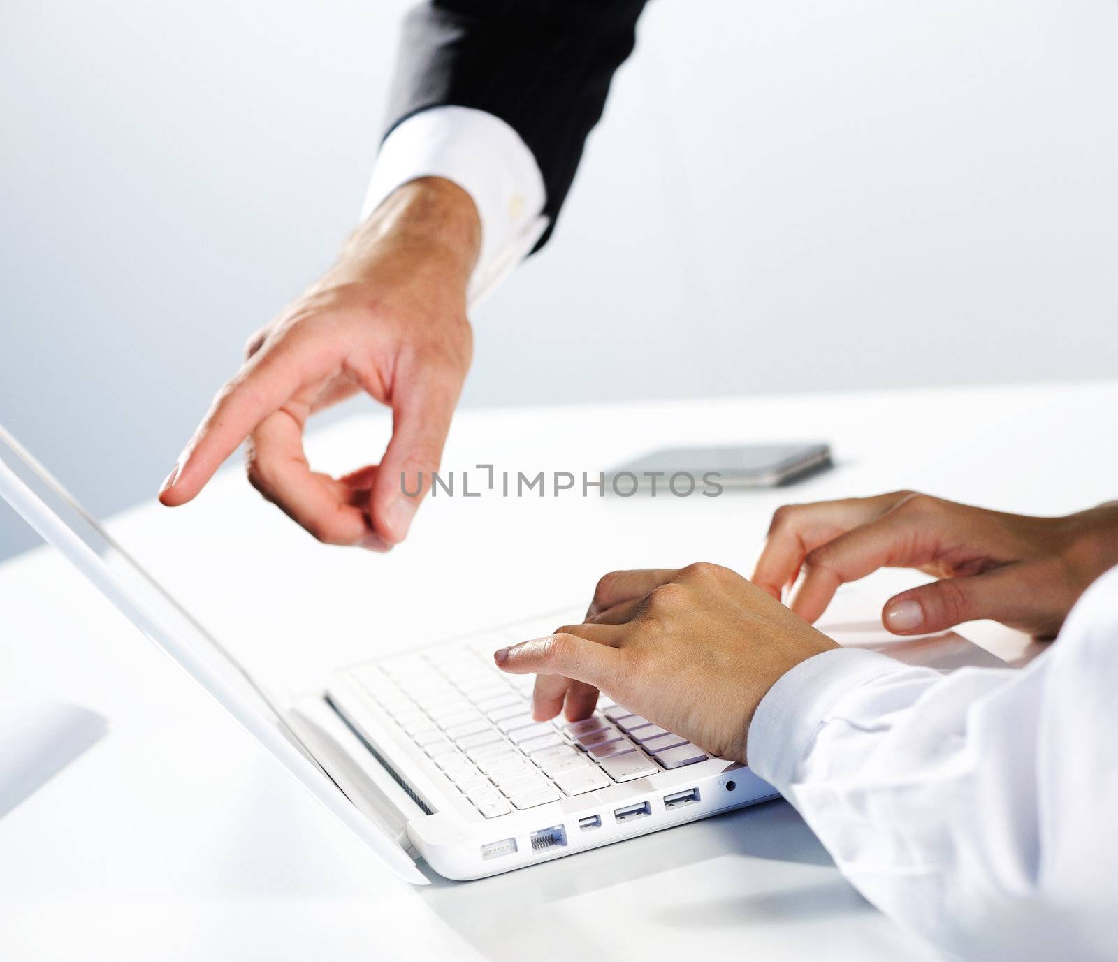  two business peoples at working on laptop