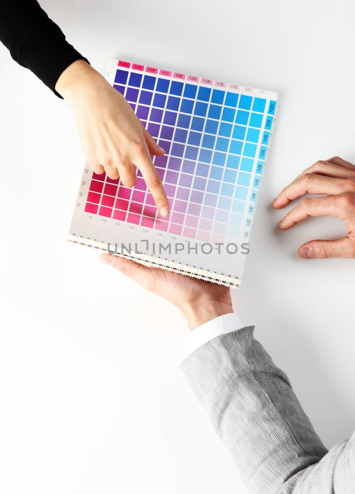 woman Choosing color from color scale, top view by stokkete