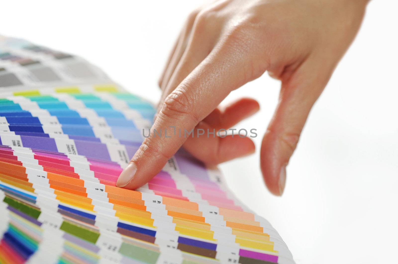 woman Choosing color from color scale by stokkete