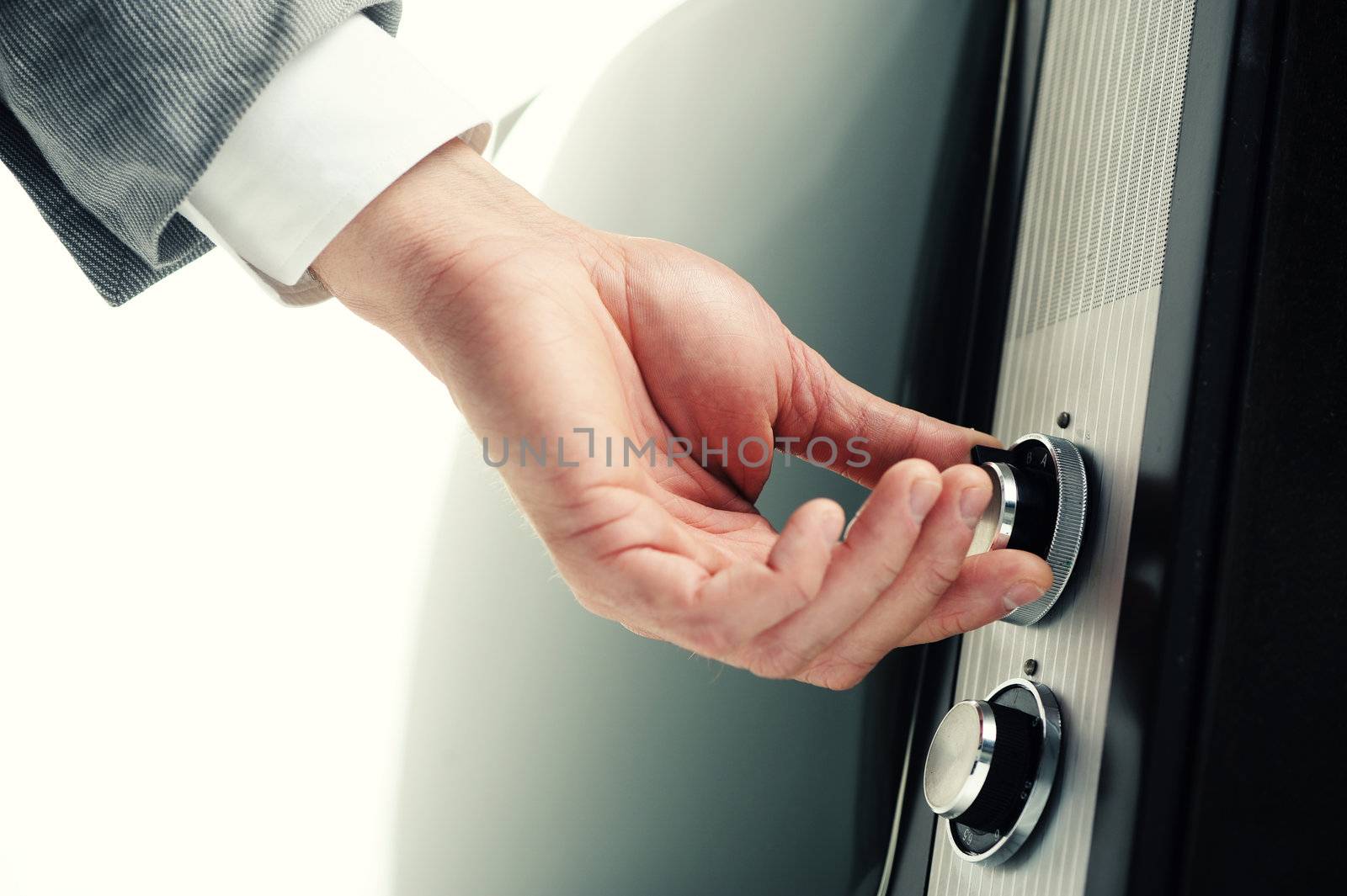 Man  turning channel knob on retro television 