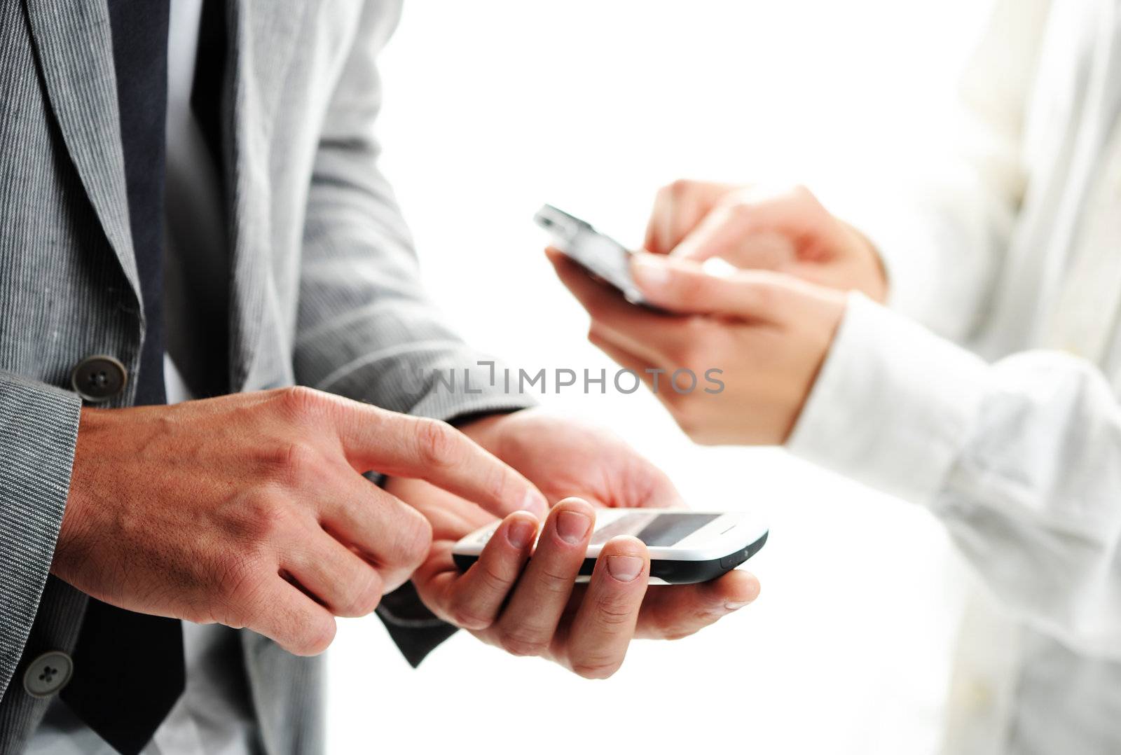 businesspeople text message on their mobile phones