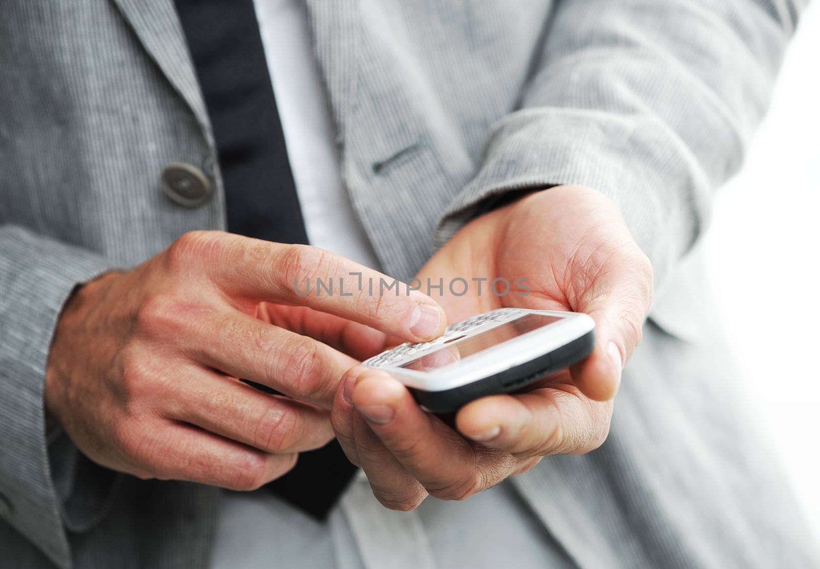 businesman with a smart phone, Closeup of hands by stokkete