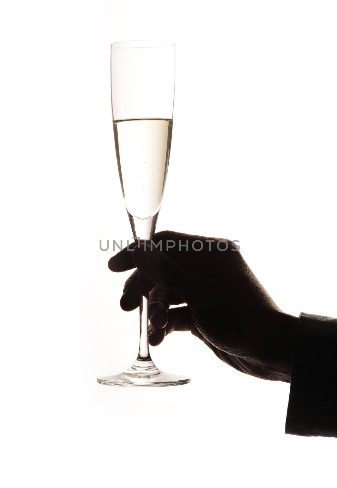 Glass of champagne in a man hand  by stokkete