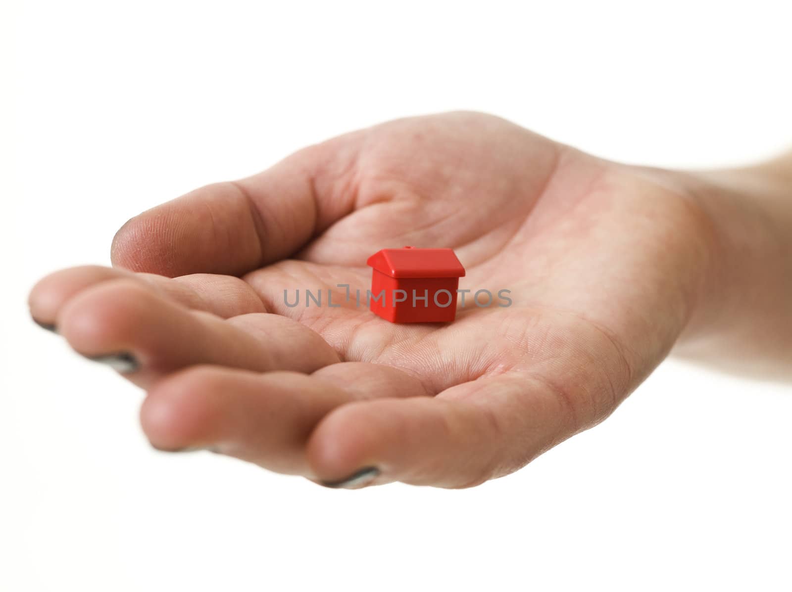 Open hand with Toy house isolated on white background