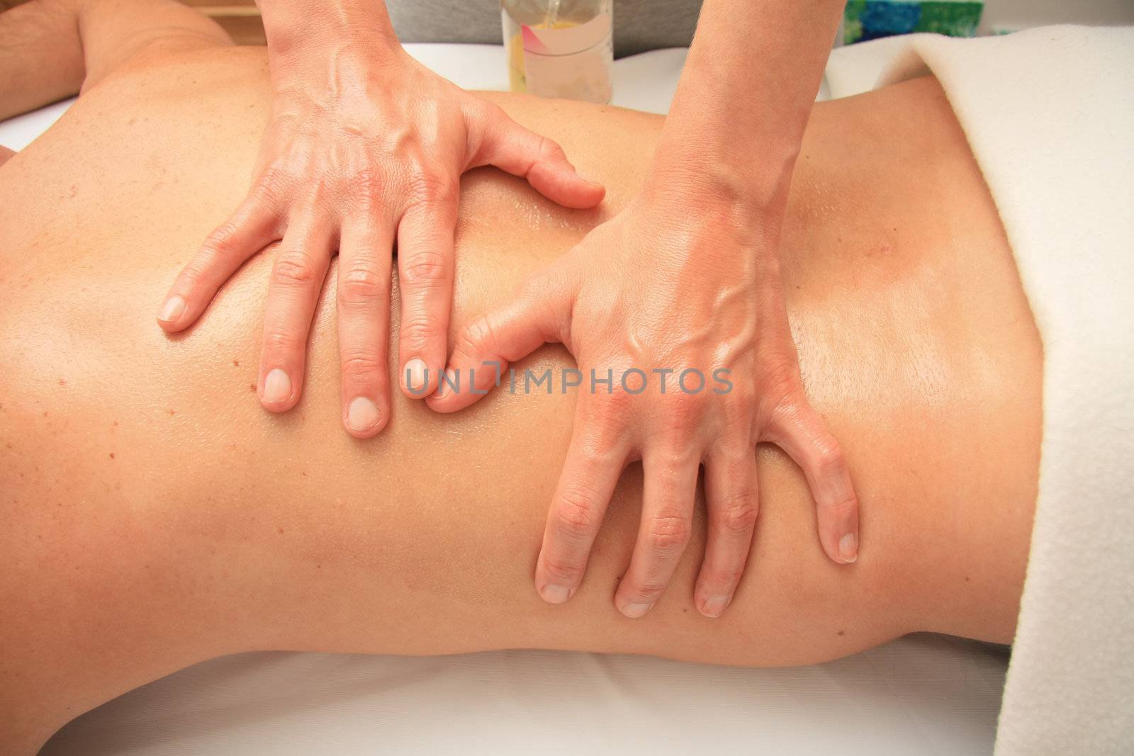 A female masseur giving a back massage