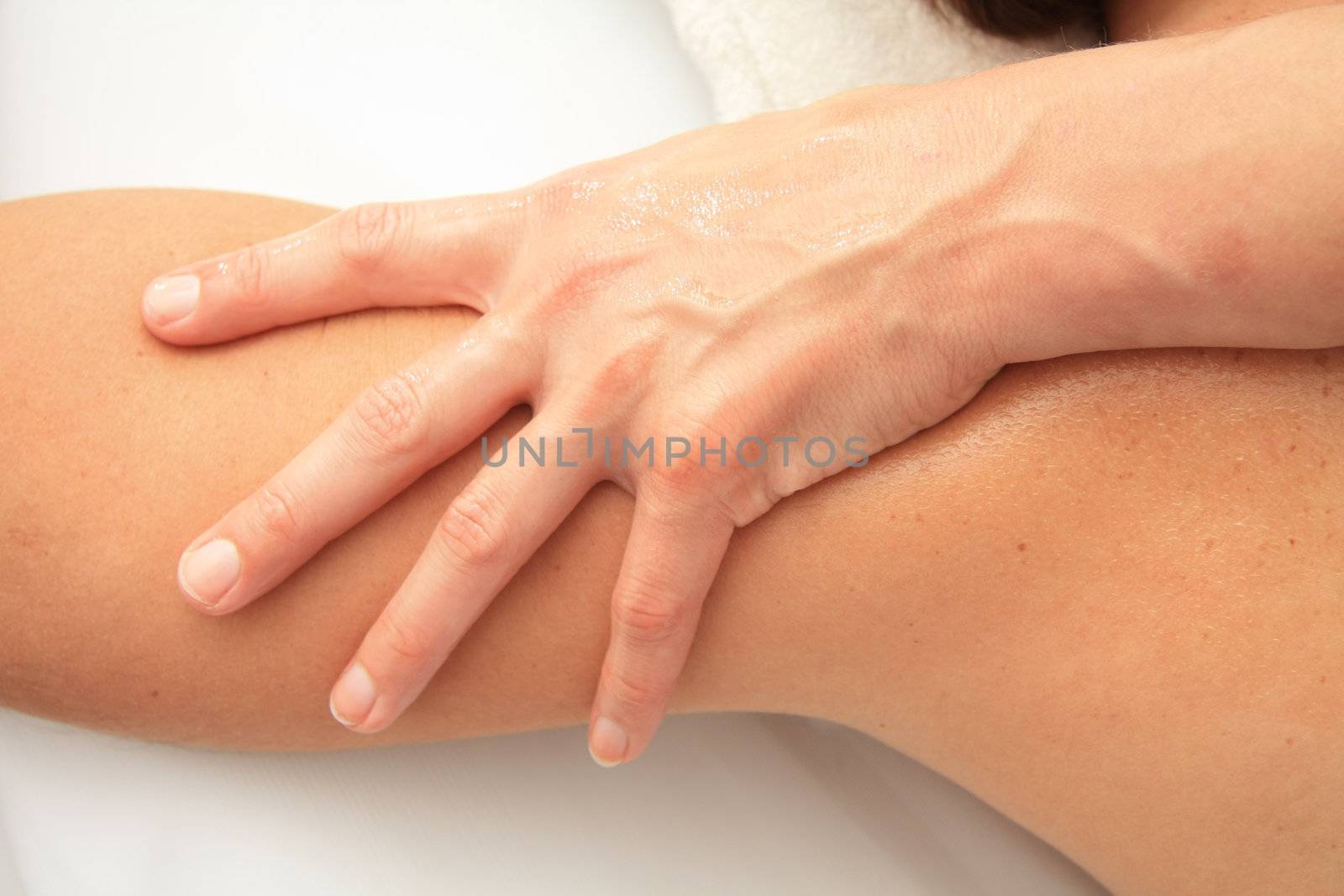 A female masseur giving massage, detail of arm