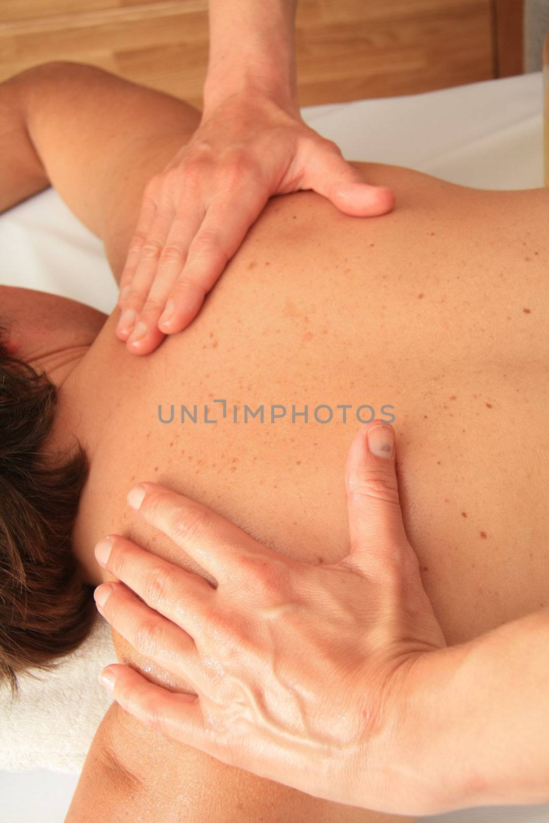 A female masseur giving a back massage