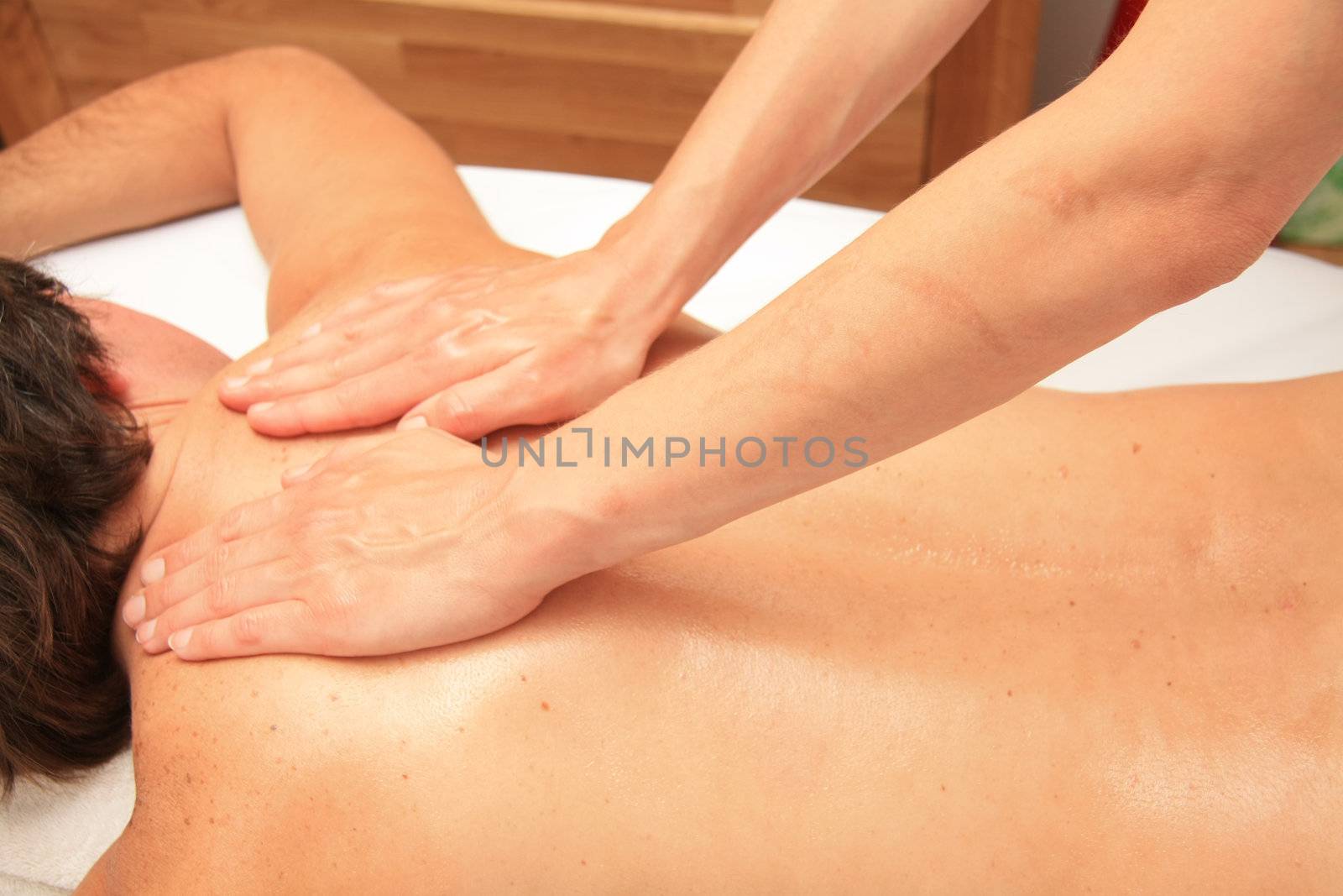 A female masseur giving a back massage