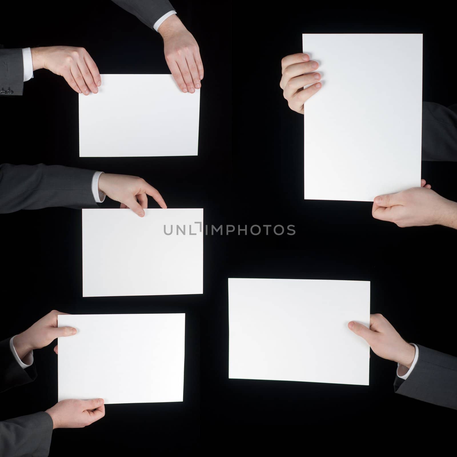 collection of hand holding blank paper on black