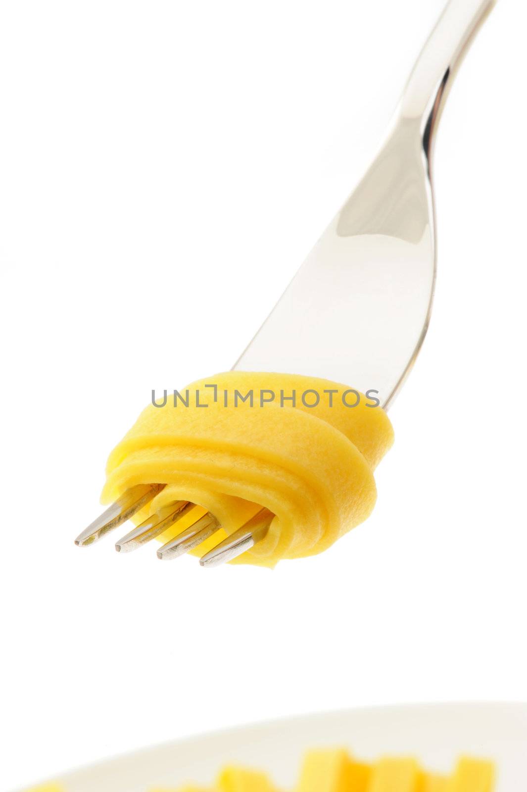 Rolled pasta on a fork, italian food by stokkete