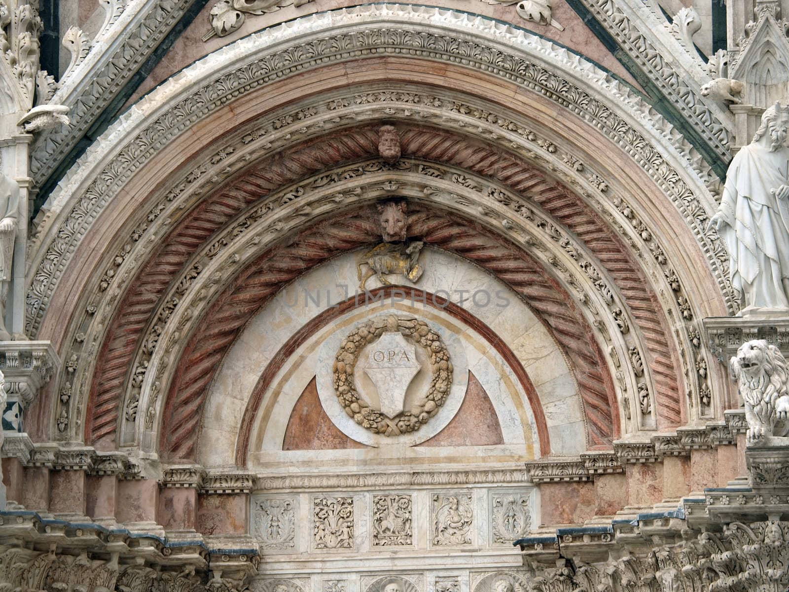 Siena - marble Duomo portal. The Duomo of Siena, which was built in the 12th and 13th centuries, is one of the prettiest churches in Gothic style in Italy