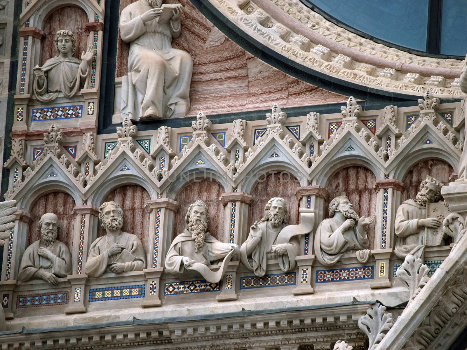 Architectural details of Duomo facade - Siena,Tuscany,Italy. The Duomo of Siena, which was built in the 12th and 13th centuries, is one of the prettiest churches in Gothic style in Italy