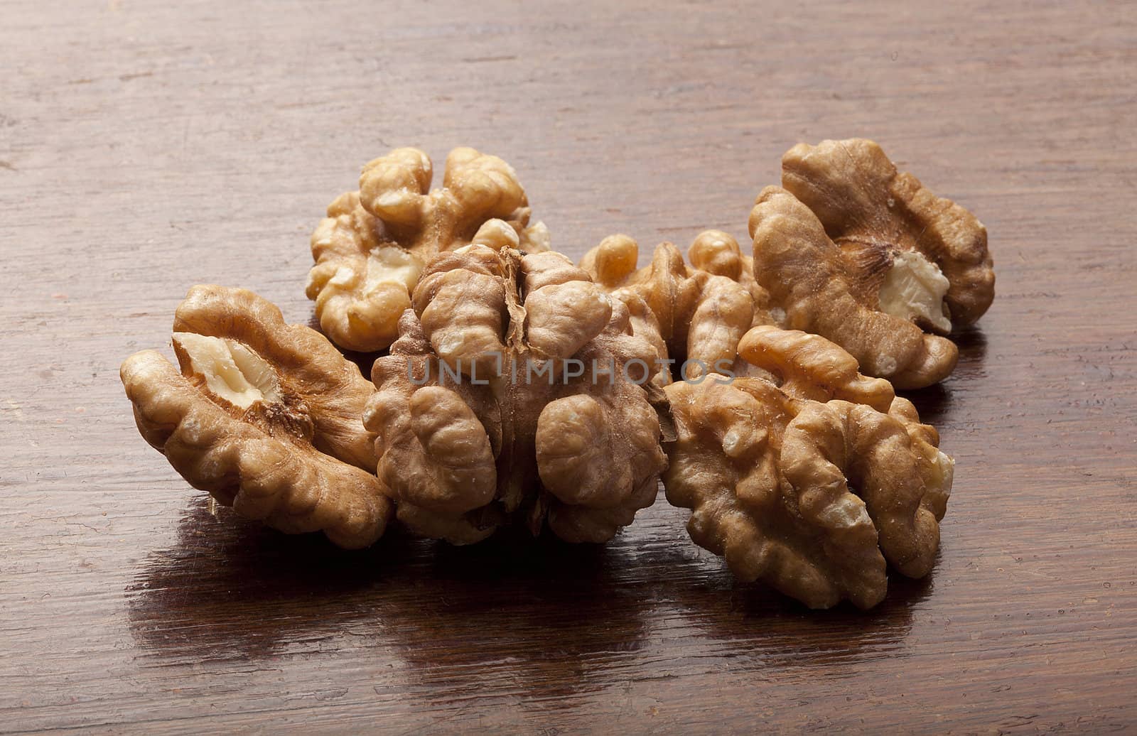 Handful of walnut on the wooden table