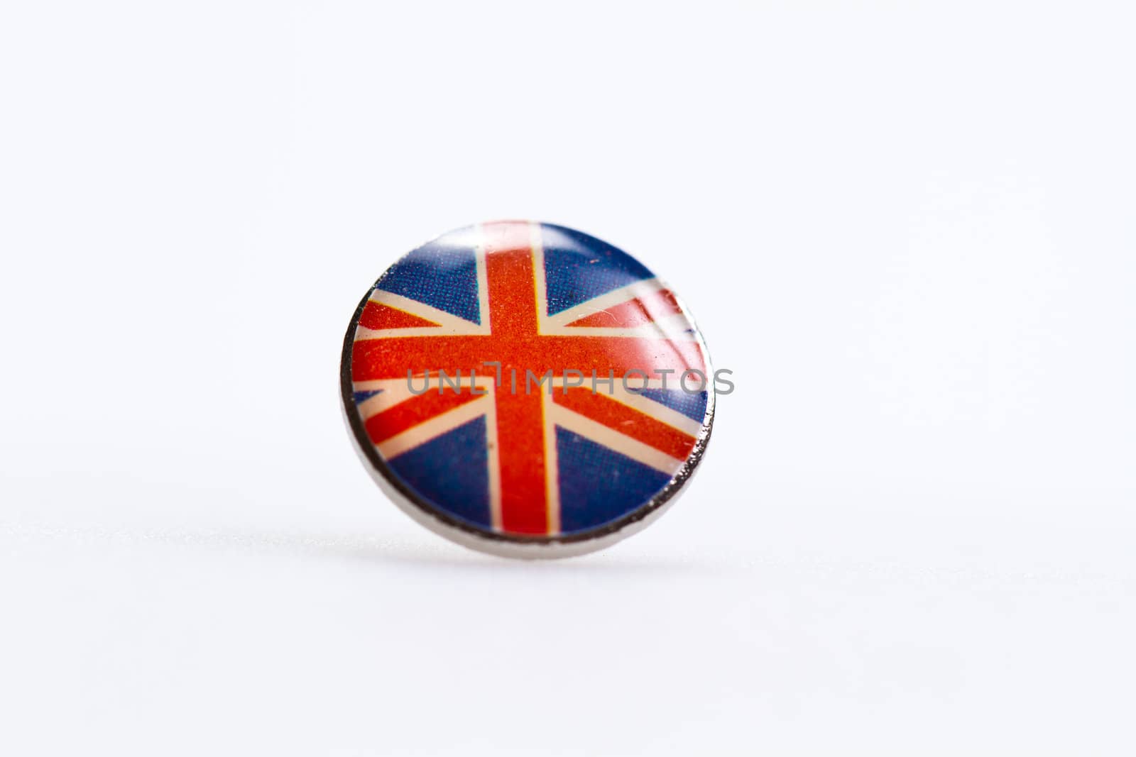 U.K flag symbol deorated on thumbtack on white sutface