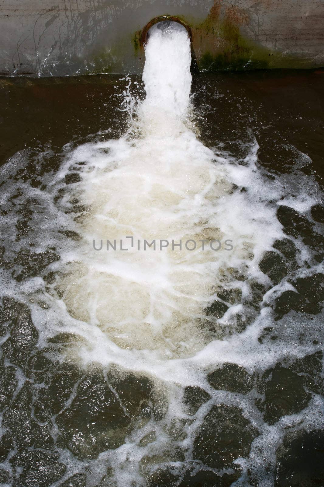 water pollution , running water from pipe into river
