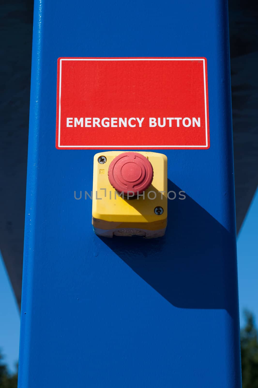 red emergency button on blue culomn