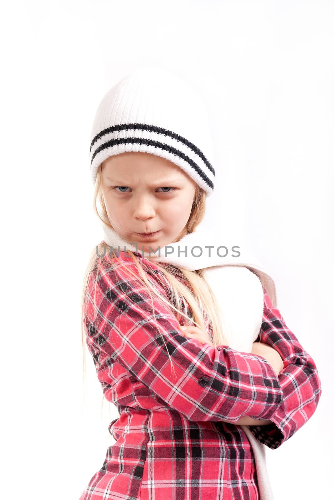 angry little girl in white hat posing over white bacground