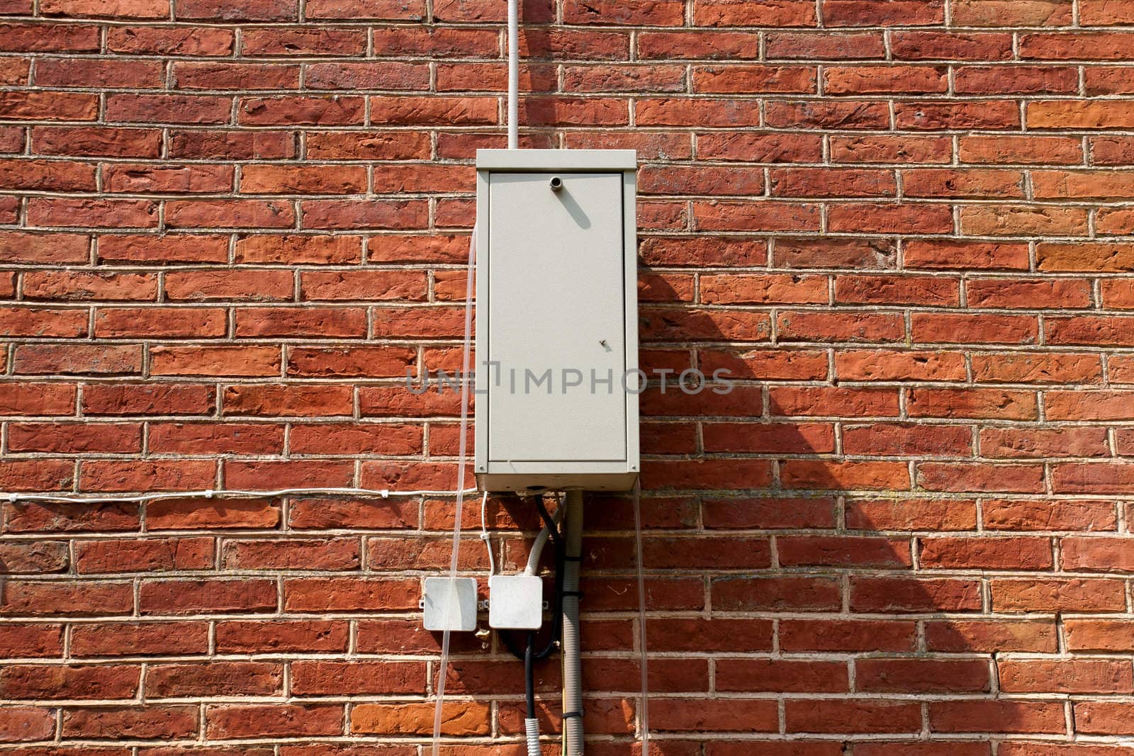 transformer and plug on red brick wall