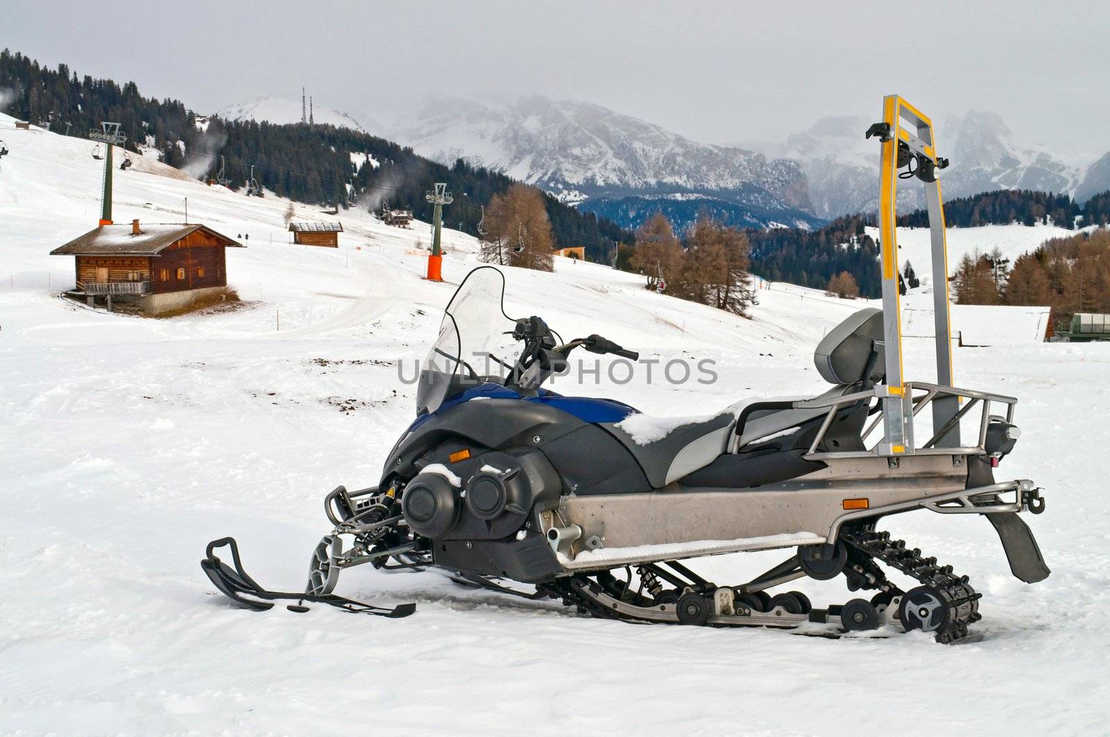 Snowmobile on alps in winter time by rigamondis