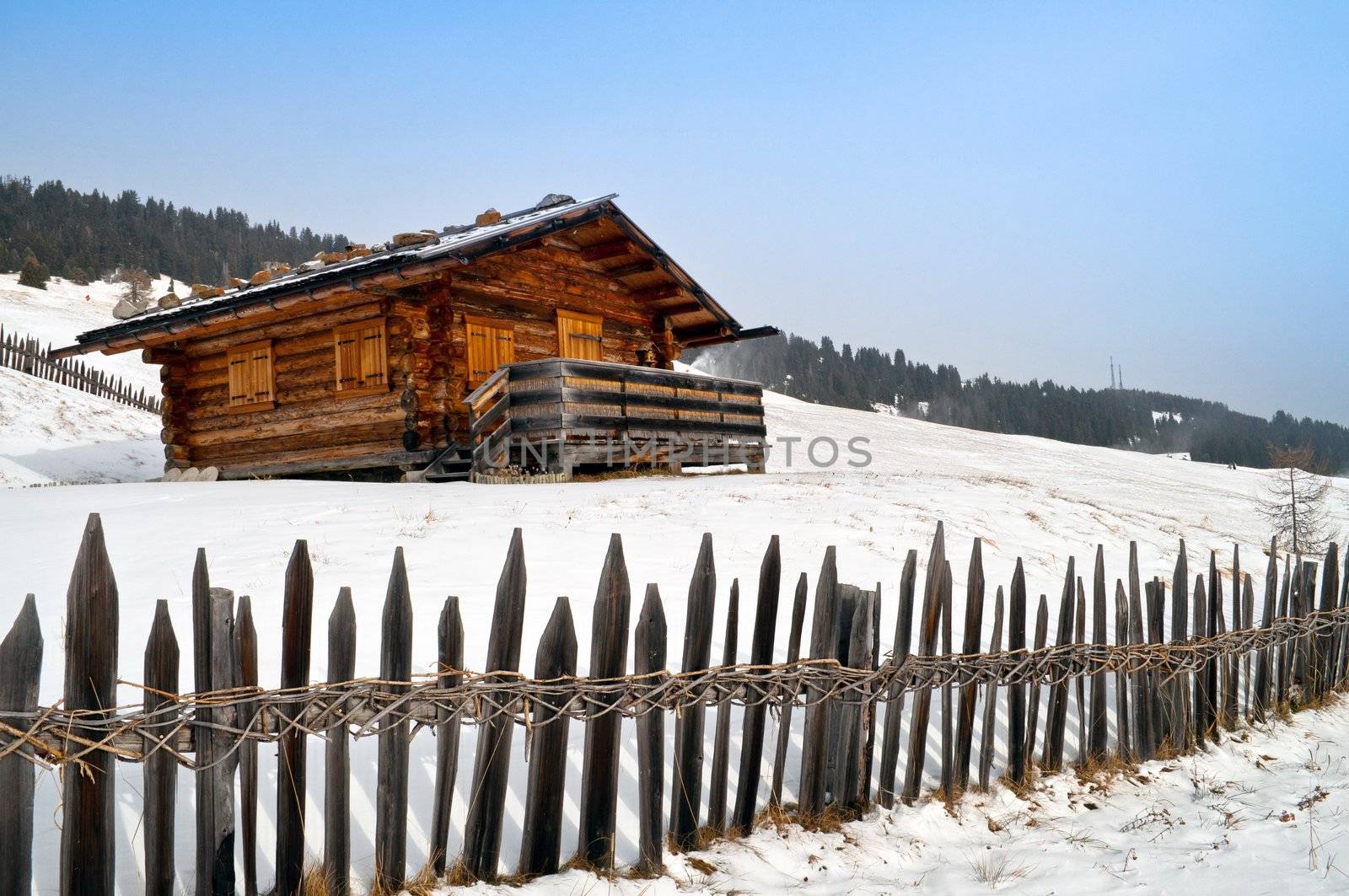 Old winter cottage with fence by rigamondis