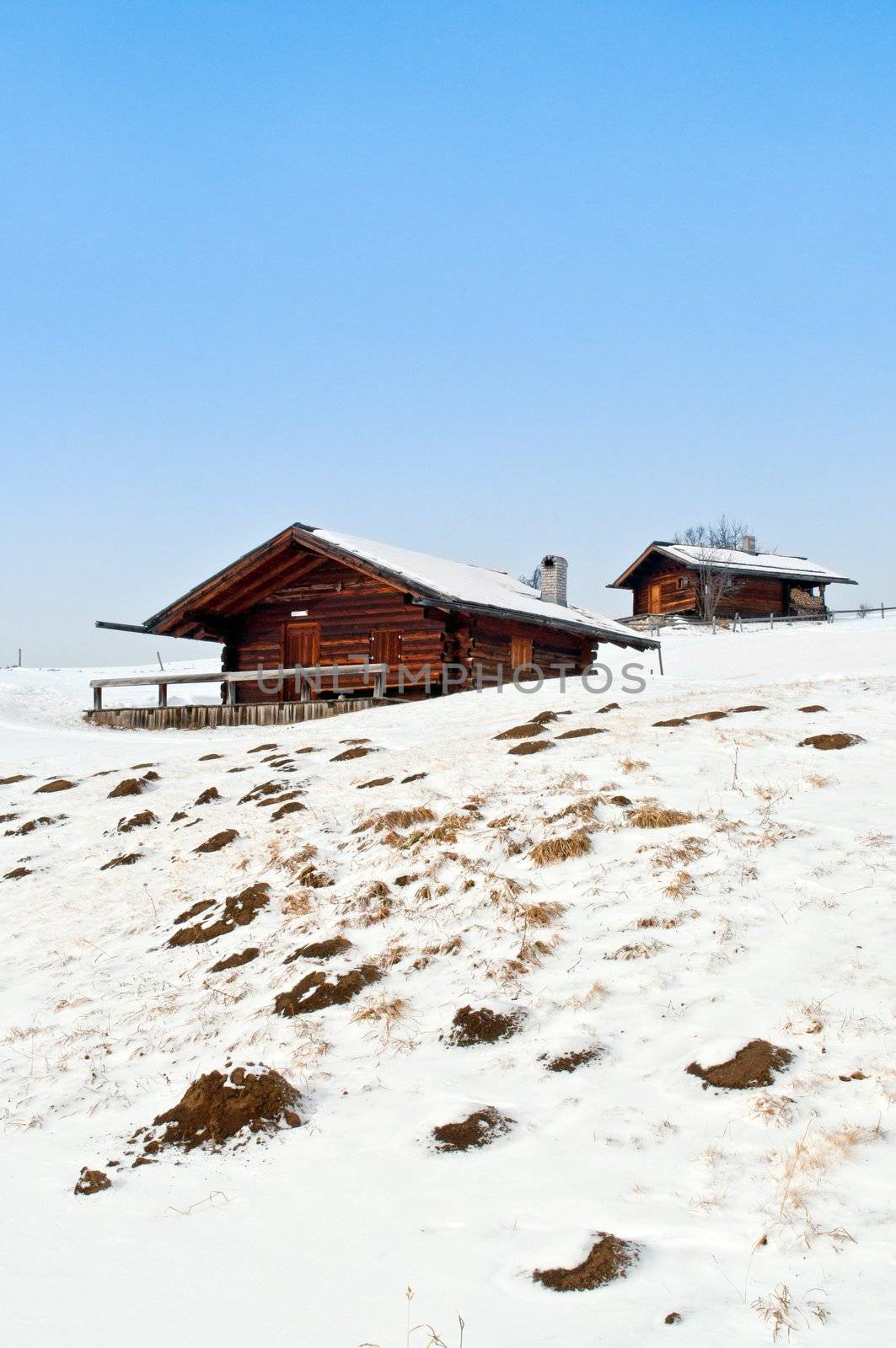 Old winter wood cottages in Dolomiti Alps, Ortisei, italy.