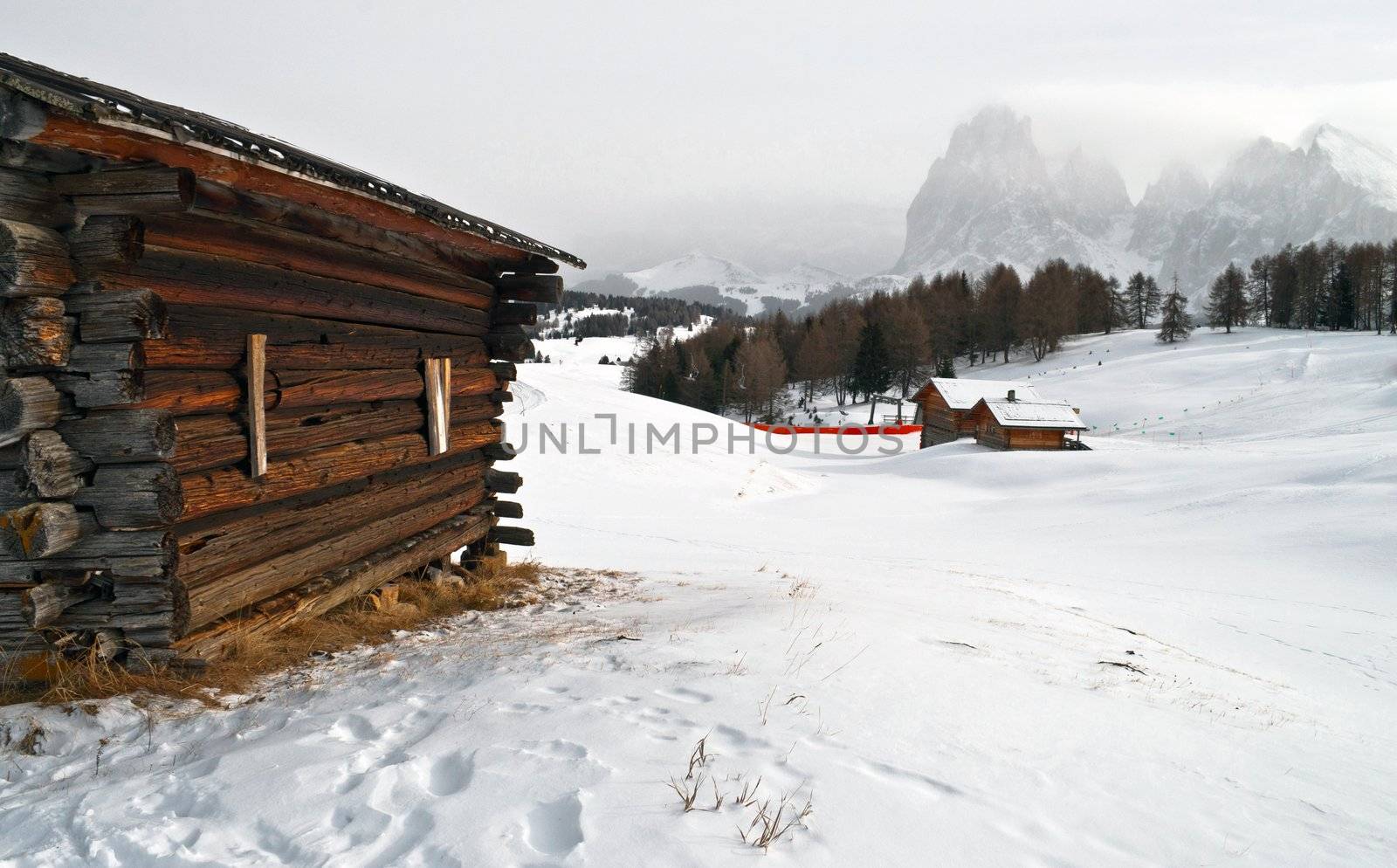 Old winter wood cottage in Dolomiti Alps, Ortisei, italy.