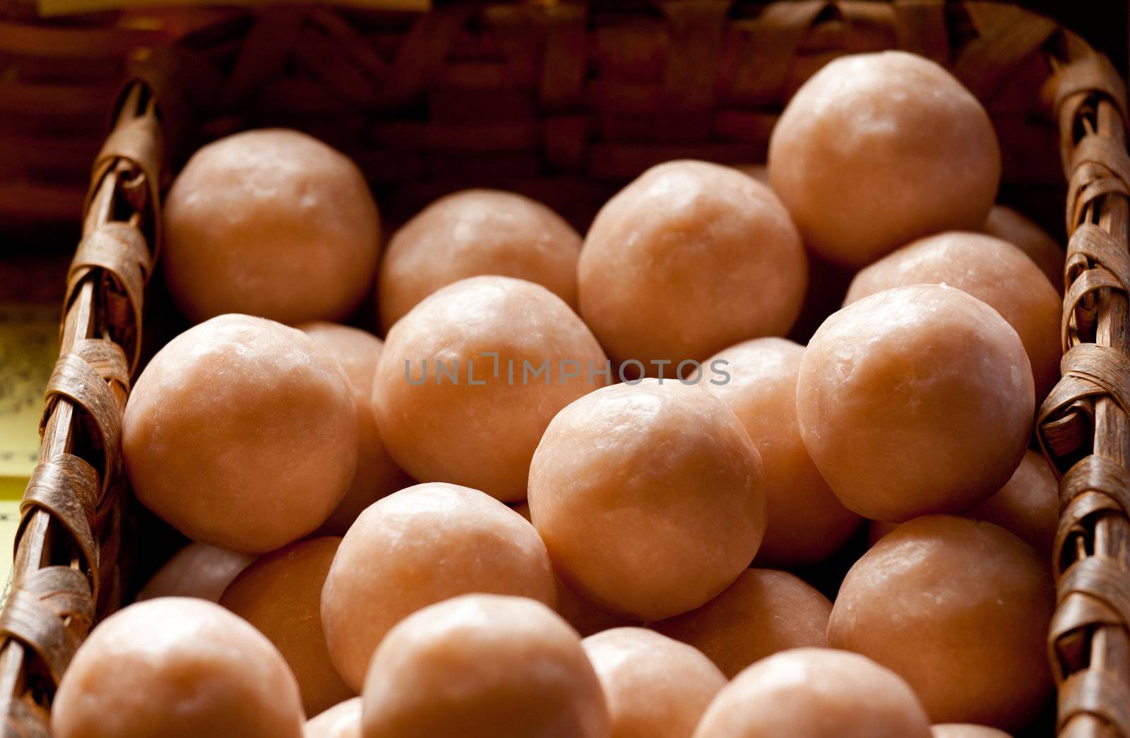 Close up of brown home made soap balls in a wicker basket
