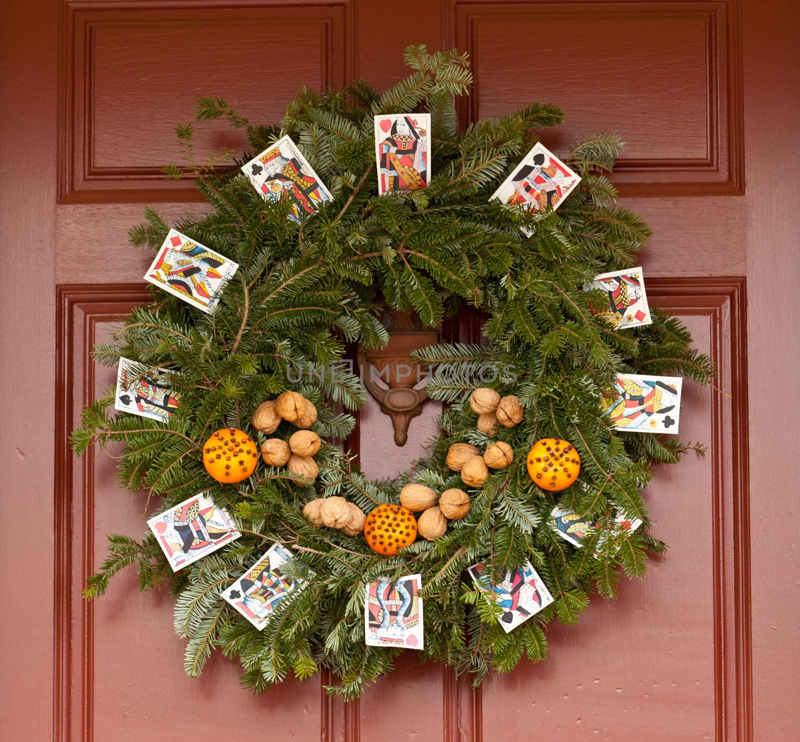 Traditional design of a christmas wreath attached to the front door of old house
