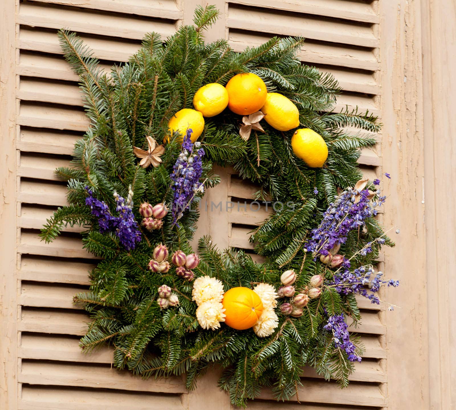 Traditional design of a christmas wreath attached to the front door of old house