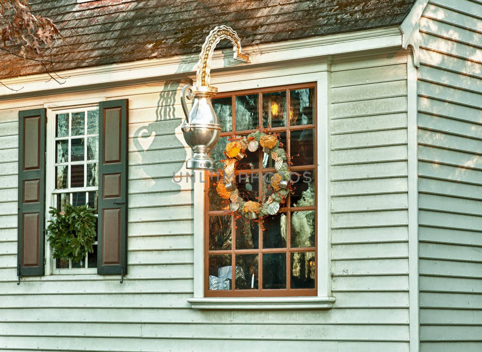 WILLIAMSBURG, VIRGINIA - DECEMBER 30: Sun rises on old shop on December 30, 2011. Colonial Williamsburg's 301 acres includes many restored buildings and houses
