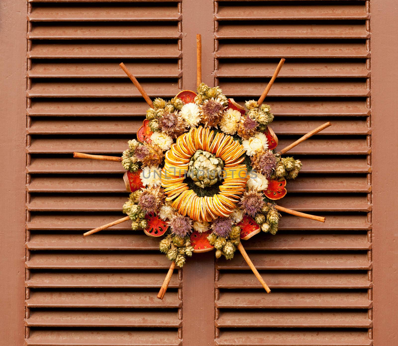 Traditional design of a christmas wreath attached to the front door of old house